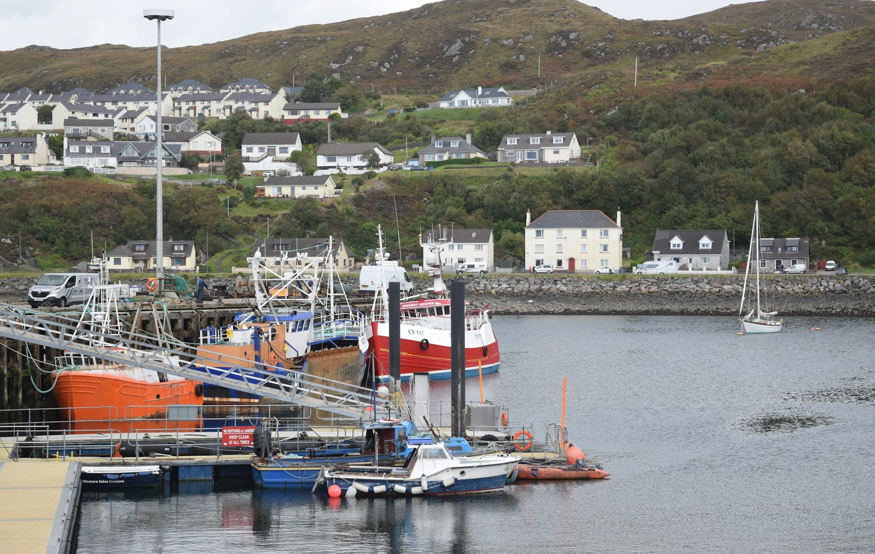 The harbour drained at low tide, boats leaning on the mud