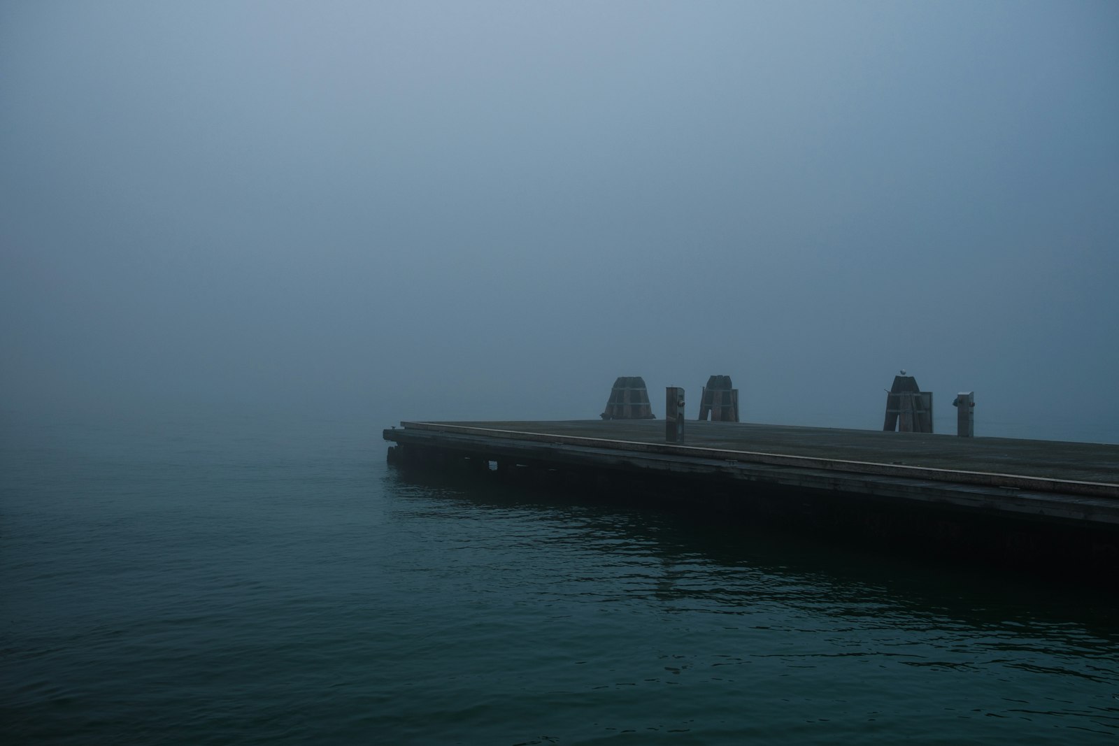 Figures on the jetty in sea mist